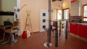 A salon with a red and white color scheme, a wooden ceiling, and a tiled floor. - Porcellana Art (Florence)