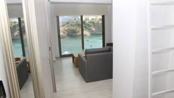 Apartment, 1 Bedroom, Sea View | Individually decorated, laptop workspace, iron/ironing board