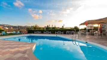Seasonal outdoor pool, open 10:00 AM to 6:00 PM, pool umbrellas