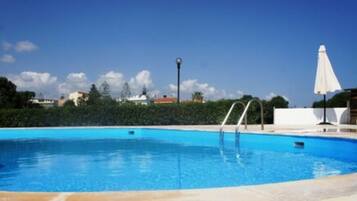Seasonal outdoor pool, open 10:00 AM to 6:00 PM, pool umbrellas