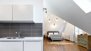 A modern loft bedroom with a sloped ceiling, a built-in bed, and a skylight. - Club Alpenresidenz Bad Gastein (Bad Gastein)