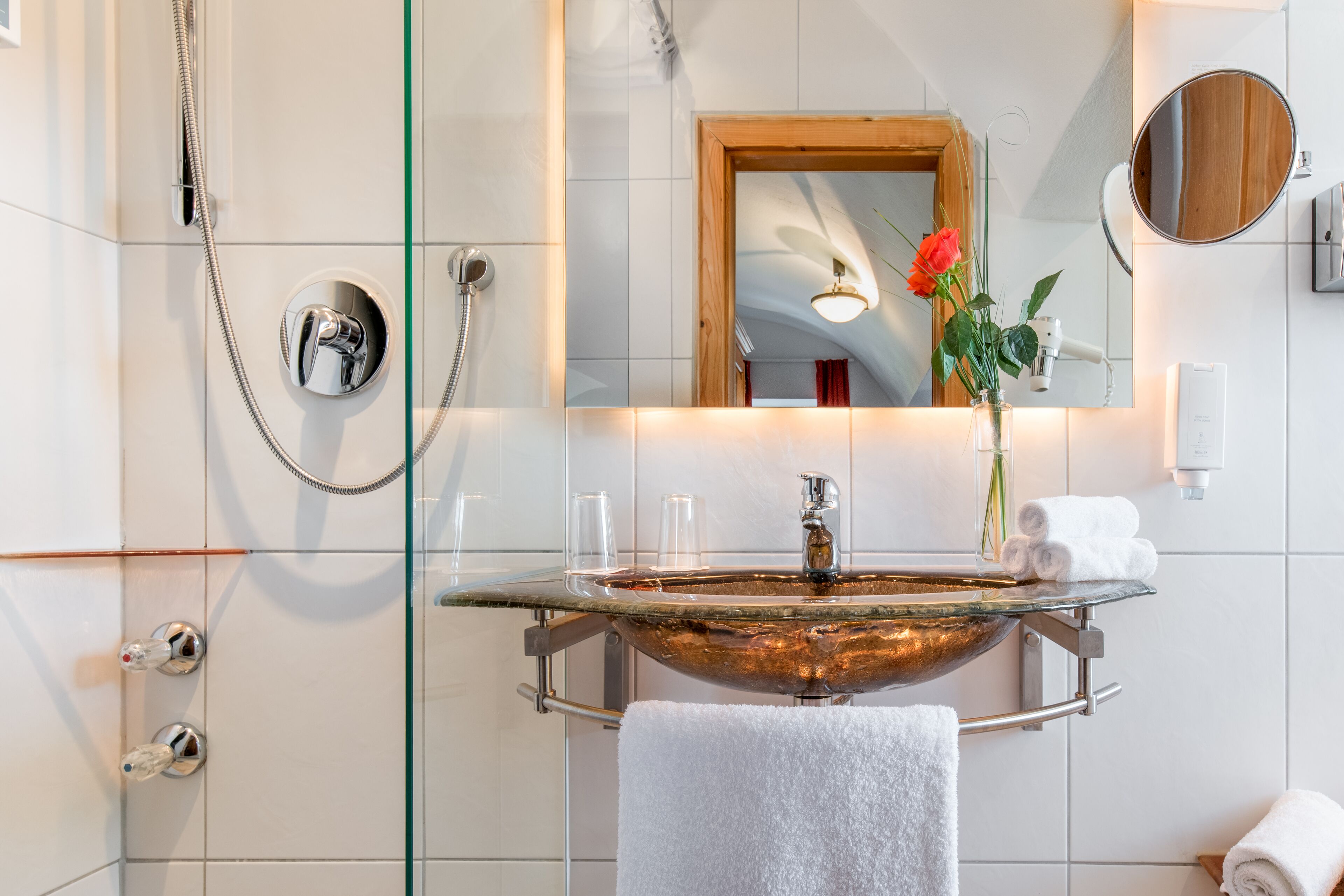 shower, hair dryer, slippers, towels