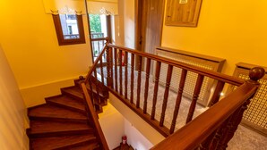 A wooden staircase with a handrail leading to a landing. - Hıdırlık Konakları (Safranbolu)