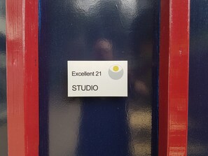 A sign with "Excellent 21 STUDIO" and a yellow circle.