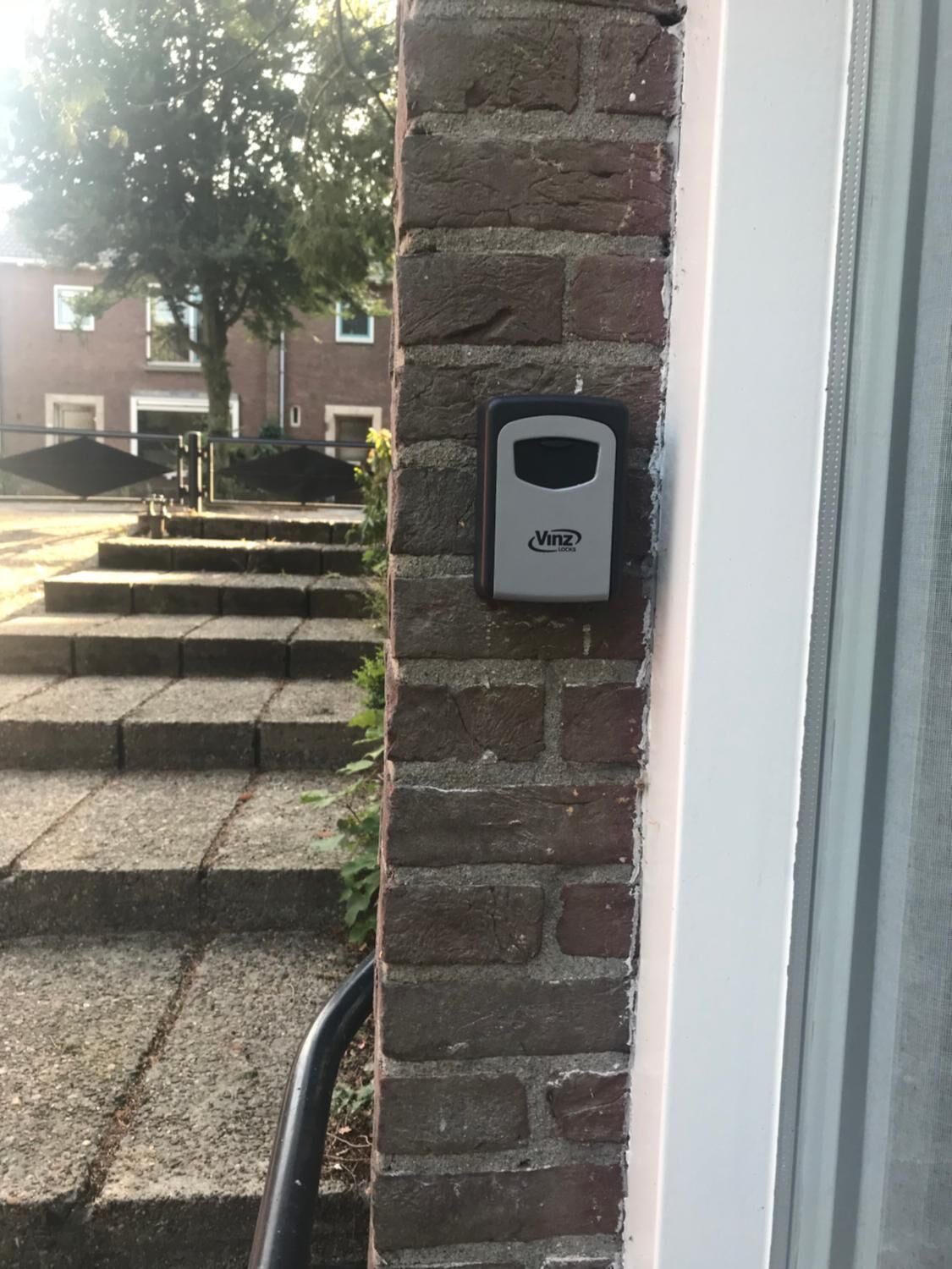 A brick wall with a door and a window.