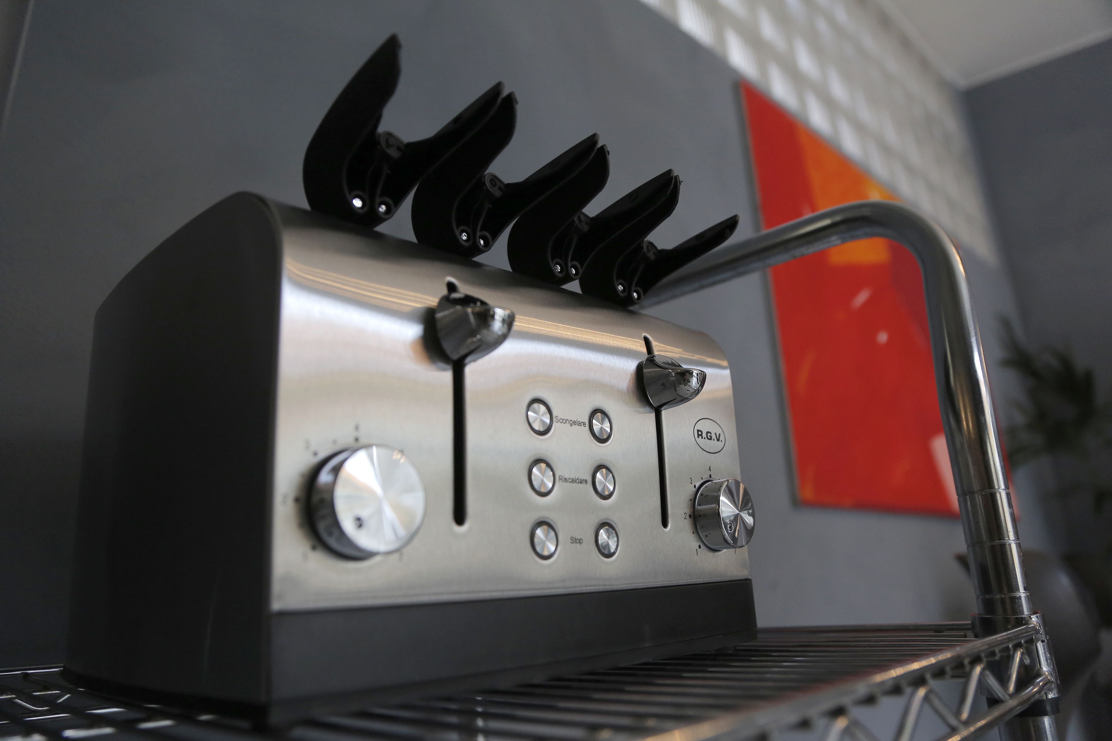 A kitchen with a stainless steel appliance, including knobs and a control panel.