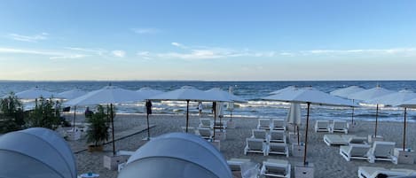 On the beach, sun-loungers, beach towels