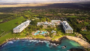 A resort with multiple buildings, a large central pool, and a beach area. - Fairmont Orchid Gold Experience (Kamuela)