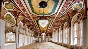 A grand hallway with ornate ceiling artwork, chandeliers, and a patterned floor. - Fairmont Royal York Gold Experience (Toronto)