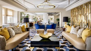 A spacious lobby with a central coffee table, sofas, and a patterned carpet. - Fairmont Royal York Gold Experience (Toronto)