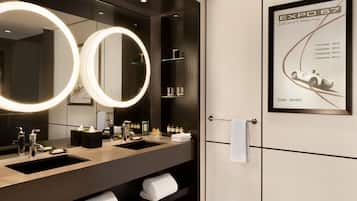 Bathroom features a double sink with a large mirror and ample storage for toiletries.