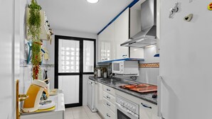 A modern kitchen with white cabinets, a built-in oven, and a microwave. - Marina Duquesa 2110 Lovely Place (Manilva)
