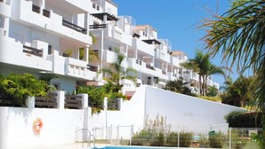 A modern building with multiple balconies and a swimming pool. - Valle Romano Estepona 2051 (Estepona)