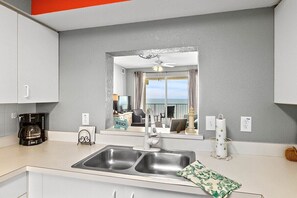 Enjoy cooking in this well-equipped kitchen with a double sink, coffee maker, and ample counter space.