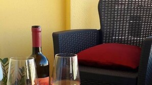 A table with two wine glasses, a bottle, and a brochure. - B&B Fradama' Holiday Dorgali (Dorgali)