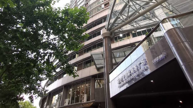 A multi-story building with a glass facade and a metal framework. - Bs Service Apartment Hotel (Shanghai)