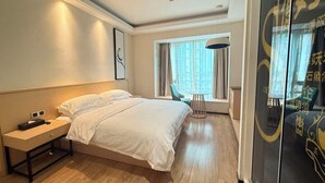 A hotel room with a bed, bedside table, lamp, and a window with curtains. - Bs Service Apartment Hotel (Shanghai)