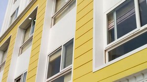A multi-story building with yellow siding and white trim. - Villa Bianca (Nainital)