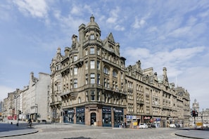 A historic building with multiple stories, large windows, and ornate architectural details.