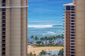 A beachfront hotel with a pool, beach, and ocean view.