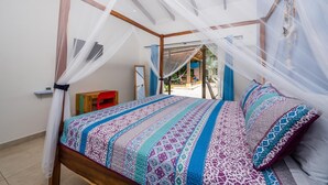 Une chambre à coucher avec un lit à baldaquin, un petit bureau et une chaise.