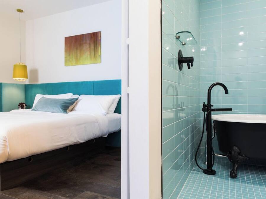A modern bedroom with a bed, a bedside table, and a nightstand.