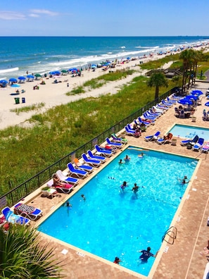 A pool area with multiple swimming pools, sun loungers, and umbrellas. - Regency Towers (Myrtle Beach)