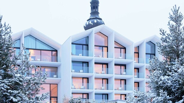 A modern building with a prominent tower and multiple balconies. - Schgaguler Hotel (Castelrotto)