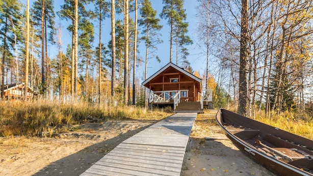 A wooden cabin with a deck leading to a dock. - Joutsen by Interhome (Jämsä)