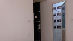 A bedroom with a bed, a wardrobe, and a bathroom visible through an open door. - Pyramids Terrace INN (Giza)