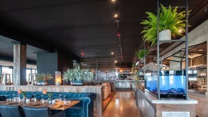 A modern restaurant with a bar area, seating, and a counter. - Oesterdam Resort by Interhome (Tholen)