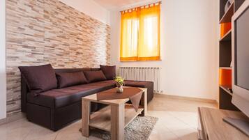Comfort Apartment, Garden View | Living area | Flat-screen TV, DVD player