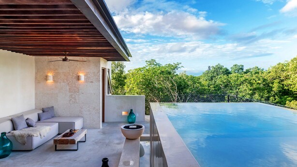 A modern outdoor living area with a pool, seating, and a view of lush greenery. - Gated Jungle Lounge • Wabi Sabi Chic Two -Level Penthouse + Private Plunge Pool  (Tulum)