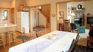 A compact living space with a kitchen, dining area, and a living room.
