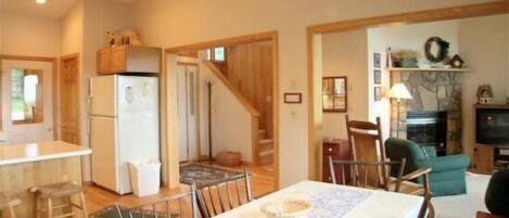 A compact living space with a kitchen, dining area, and a living room.