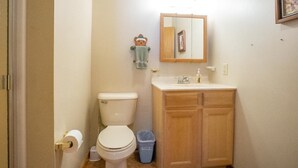A bathroom with a toilet, sink, and mirror. - Mountain Treat (Davis)