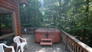 A wooden deck with a hot tub, two white plastic chairs, and a wooden railing. - Laird`s Retreat (Davis)