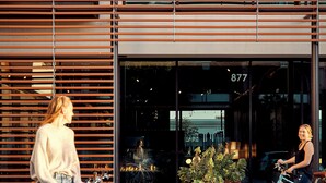 A modern building with a large glass entrance, numbered 877, and a row of bicycles parked outside. - Hotel San Luis Obispo (San Luis Obispo)