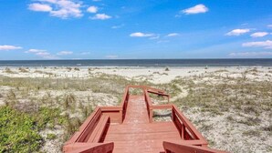 A wooden boardwalk leading to a beach with dunes and a clear blue sky. - Amelia Retreat C 3 - Hosted by Moore AI Rentals (Fernandina Beach)