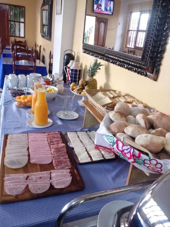 A breakfast buffet with various food items and beverages.