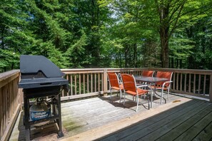 A deck with a grill, a table, and chairs. - Gnarnia (Davis)