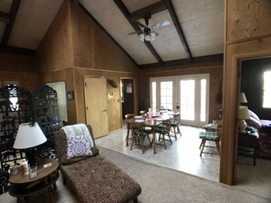Relax in this airy room with a cozy seating area, dining table, and large window.