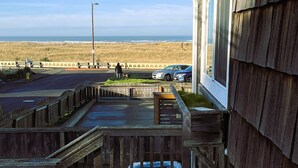 A wooden deck with a view of the beach and ocean. - Absolutely fantastic, charming retreat with ocean views! (Seaside)