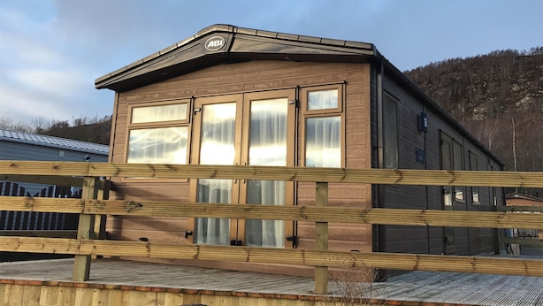 A two-story building with a wooden facade and large windows. - Cairngorms Flower Lodge (Aviemore)