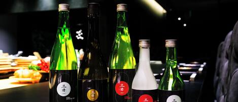 A selection of bottles with labels on a bar counter.