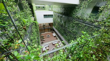 A rooftop garden with seating areas and a view of the surrounding buildings.
