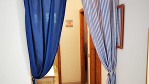 Un pasillo con piso de madera, una puerta de madera y un letrero que dice 'BEACH'.