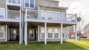 A two-story house with a covered porch and a balcony. - Perfect family vacation, Open floor plan, Relaxed coastal living (Millville)