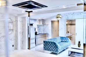 A modern interior with a sofa, a kitchen, and a bathroom. - The Root2 Hotel (Kyoto)