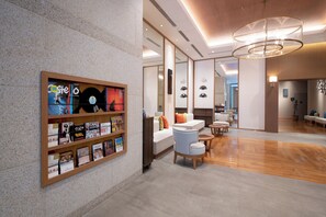 A modern interior with a music-themed wall display, a seating area with sofas and a coffee table, and a wooden floor. - Hotel Vista Fukuoka Nakasu-Kawabata (Fukuoka)